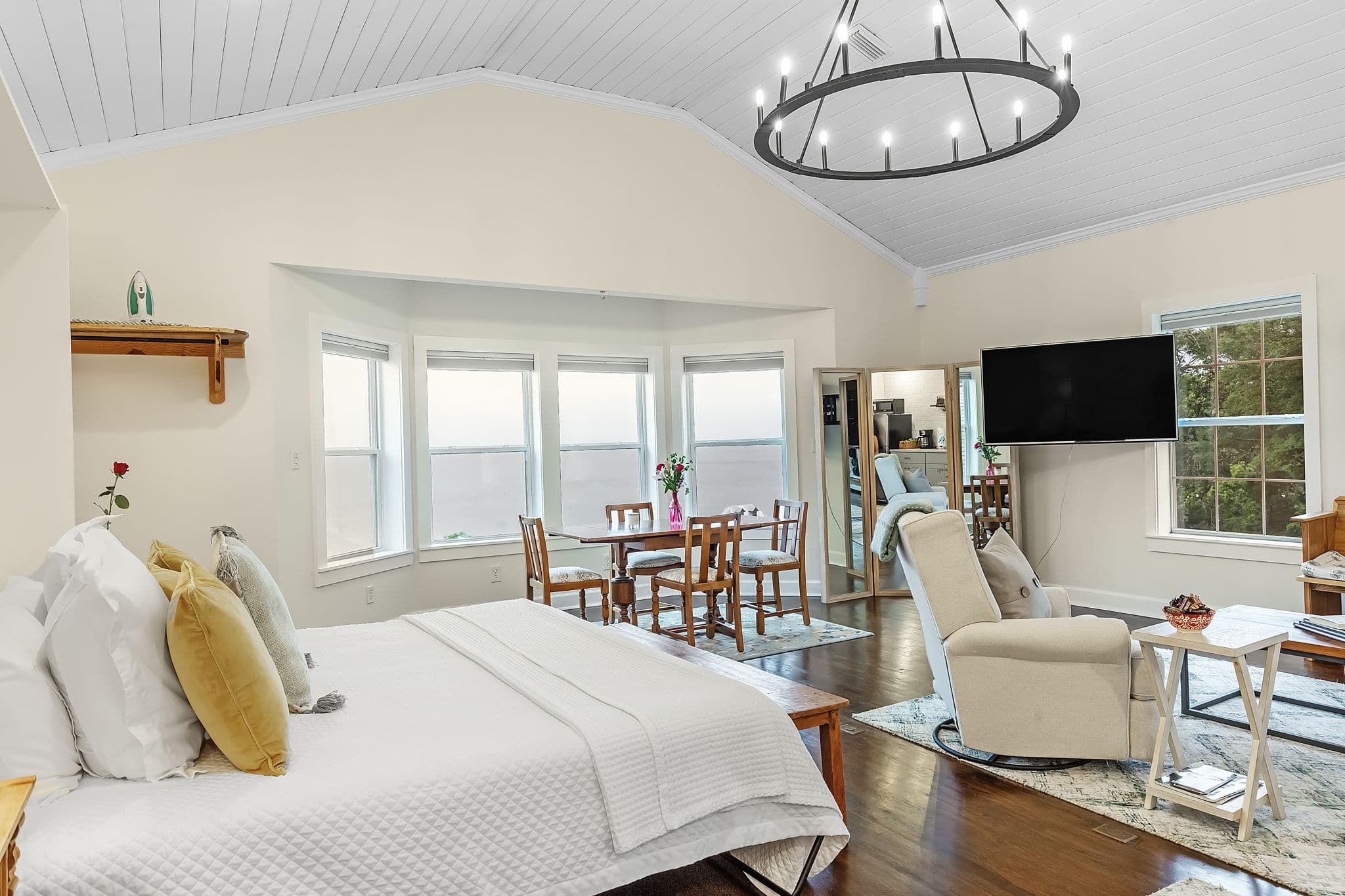 Cozy room with a bed, dining area, and large windows offering a view.